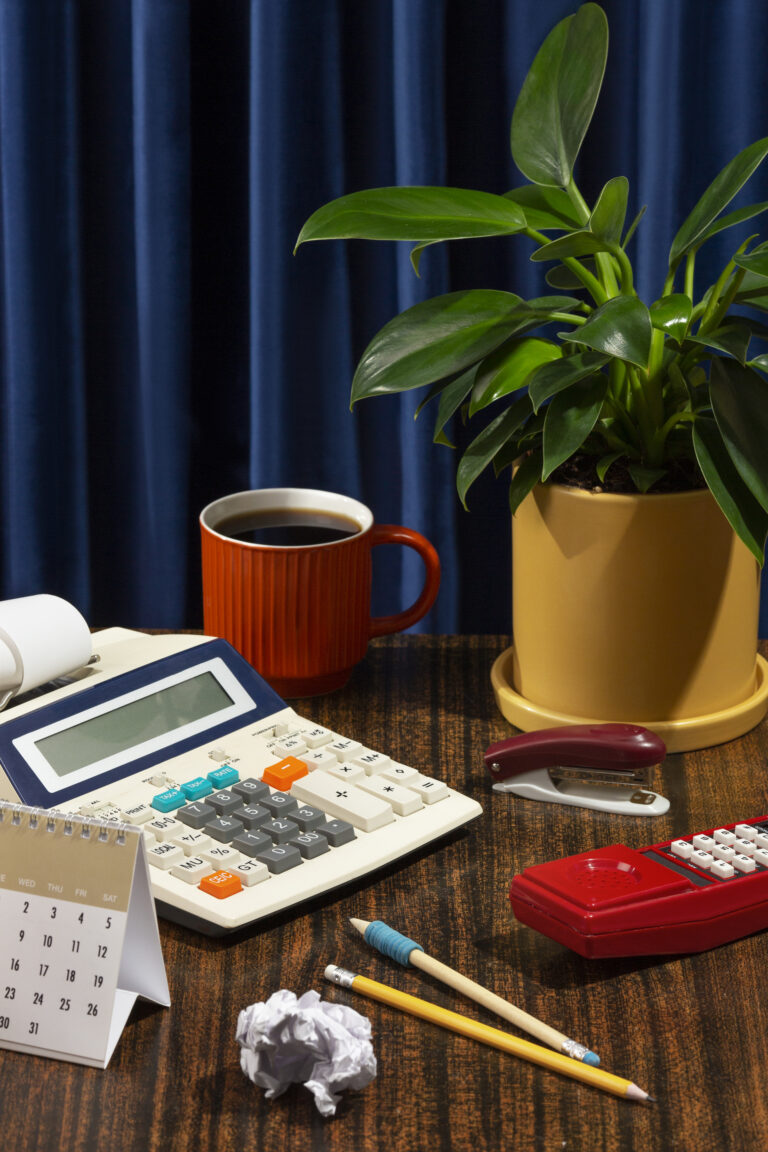 A desk with a calculator someone working on taxation