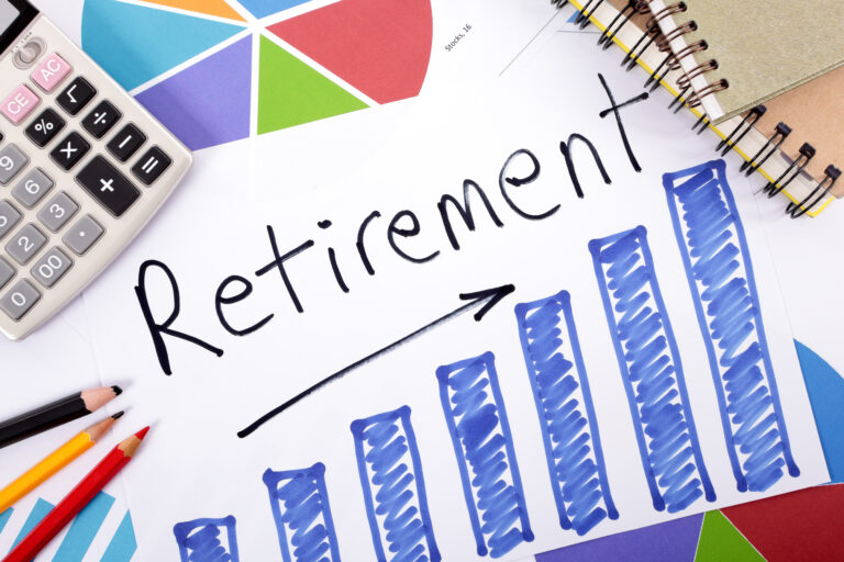 Retirement planning workspace showing an ascending blue bar graph next to 'Retirement' text, calculator, and colorful pie chart—illustrating how interest rate environments impact guaranteed lifetime income annuity performance and growth potential.