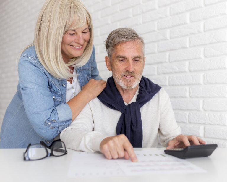 Mature couple planning retirement with calculator discussing guaranteed lifetime income annuity options